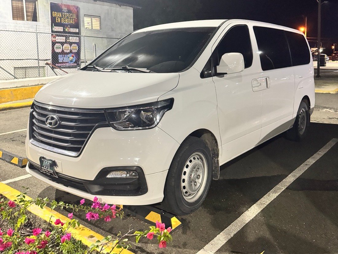 White Hyundai H1 passenger van, one of the vehicles used by Yin Transfers & Tours